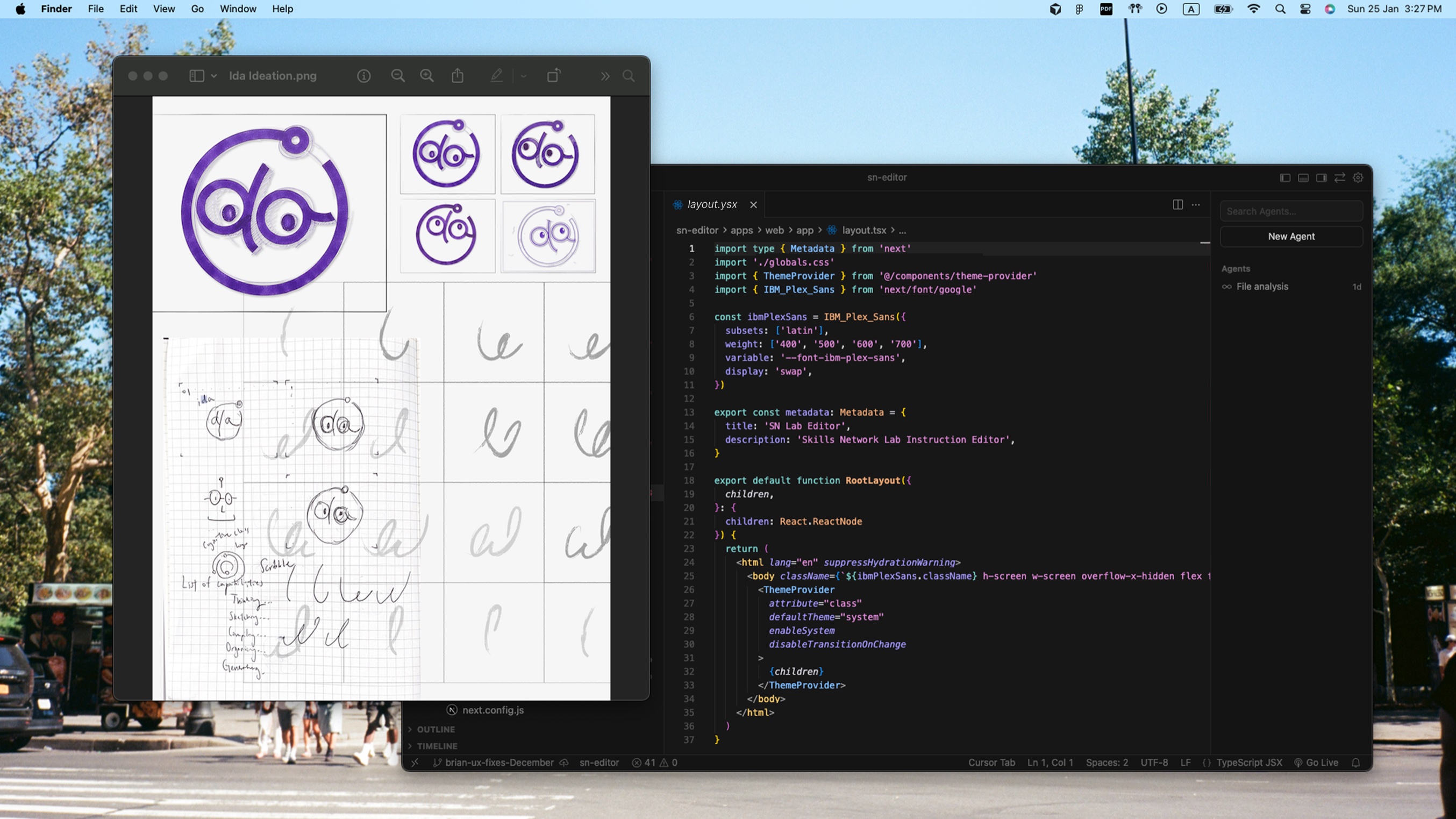 A laptop showing early Ida logo ideation sketches next to a code editor with the new SkillsNetwork editor open, taken on a New York street corner.